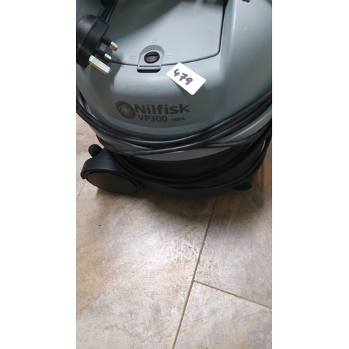 479 - Nilfisk VP300 HEPA vacuum cleaner features a durable design and efficient HEPA filtration system. It... 