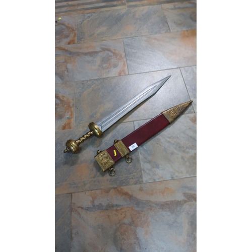 53 - Romano-British replica gladius with scabbard, enhanced with brass detailing and red leather. Exempli... 