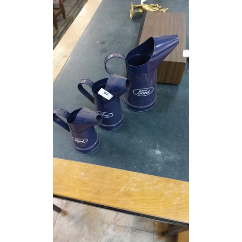 62 - Set of three vintage Ford-branded blue metal oil cans