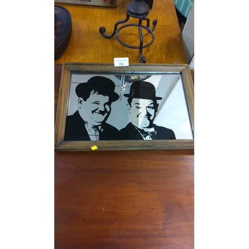 74 - Vintage framed mirror featuring iconic Laurel & Hardy duo silhouette, from the mid-20th century.