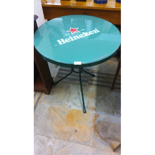 98 - Heineken-branded metal bistro table features a vibrant green top and sturdy cast iron base design.