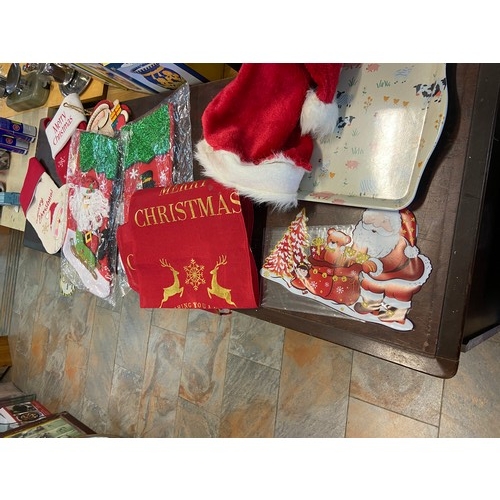 497 - Assorted Christmas decorations, including Santa-themed stockings and festive tableware.