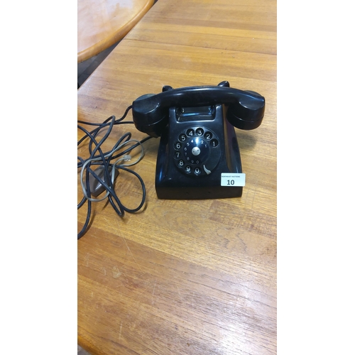 10 - Vintage rotary dial telephone from the mid-20th century. Glossy black bakelite finish, complete with... 