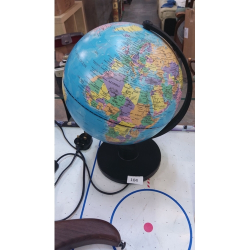 104 - Illuminated world globe on a black base, modern design with vibrant detailing, complete with power c... 