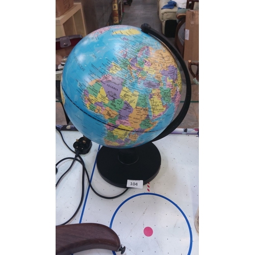 104 - Illuminated world globe on a black base, modern design with vibrant detailing, complete with power c... 