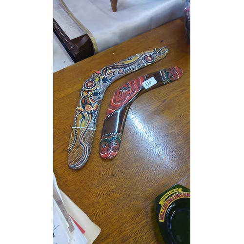 110 - Pair of hand-painted decorative boomerangs feature vibrant indigenous-inspired art on crafted wood w... 