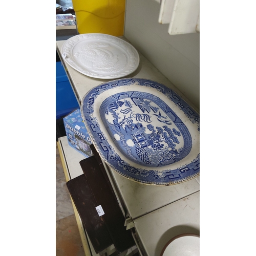 130 - Blue and white Willow-pattern porcelain platter from the mid-20th century, paired with a raised-reli... 