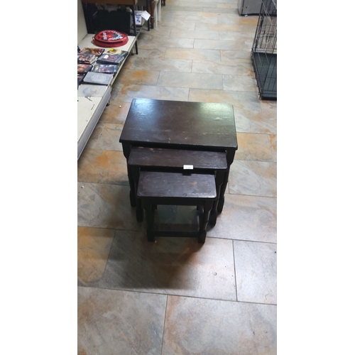 138 - Vintage nesting table set, crafted in dark-stained wood. Three graduated tables.