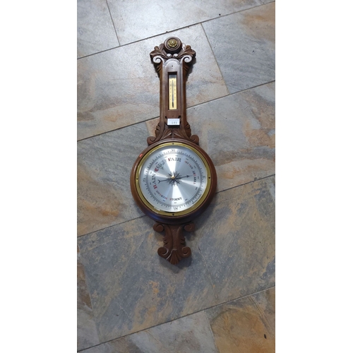 141 - Late 19th-century carved wood aneroid barometer and thermometer, featuring ornate scroll details and... 