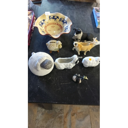 143 - Mixed lot includes a ceramic cow bowl, animal-themed creamers, ceramic sheep bank, and decorative fi... 