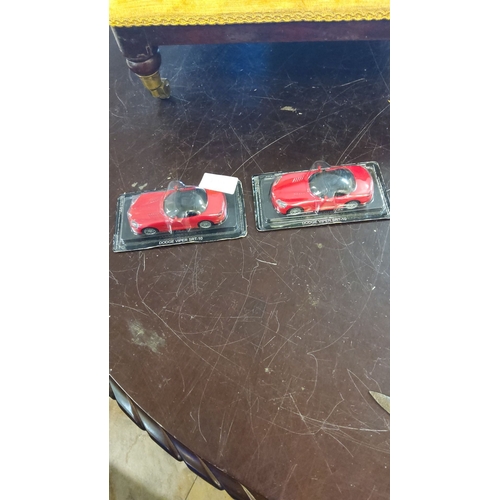 179 - Set of two collectible Dodge Viper SRT-10 die-cast models, mint in original packaging. Features vibr... 