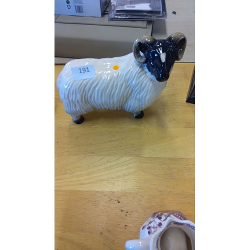 191 - Ceramic sheep figurine, hand-painted with black head and horns, textured fleece detailing. Measures ... 