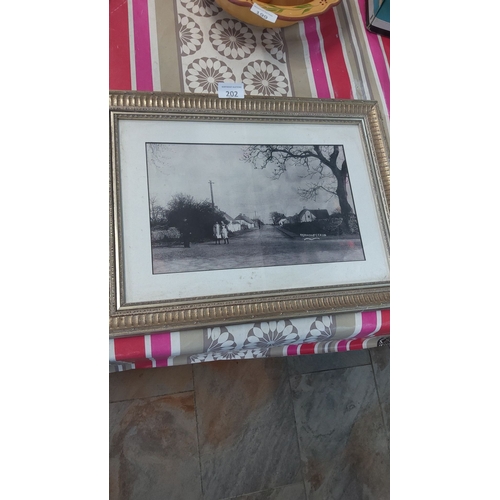 202 - Framed black-and-white village scene photograph, marked 