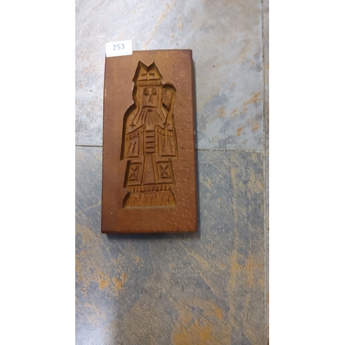 253 - Hand-carved wooden cookie mold features a detailed figure design, from European origin.