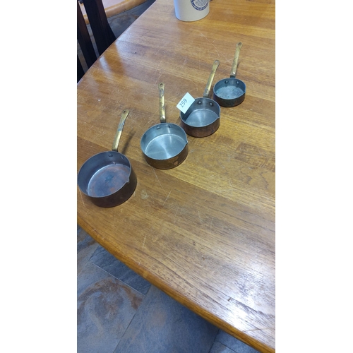 259 - Set of four vintage copper and brass miniature saucepans with riveted handles. Features a charming p... 