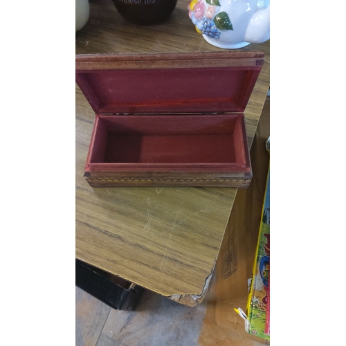 26 - Ornately carved wooden jewelry box with intricate floral motifs, hinged lid, and red velvet-lined in... 