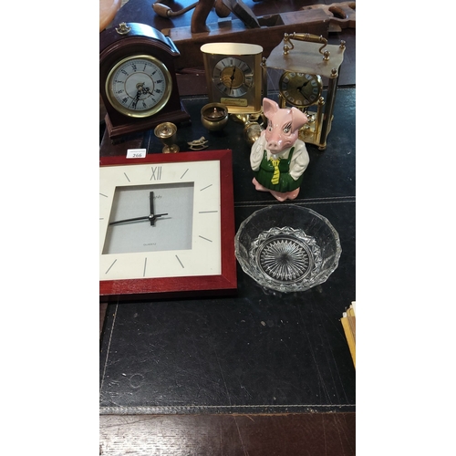 266 - Collection of vintage clocks and collectibles, including brass and wood mantle clocks, a ceramic pig... 