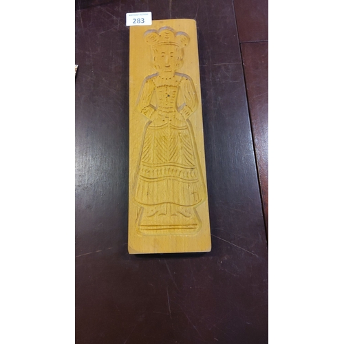 283 - Wooden cookie mold, early 20th century, carved figure of a woman in traditional dress.