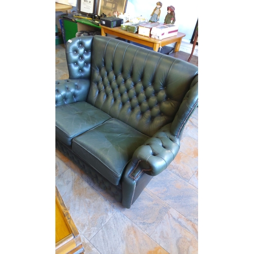 292 - Vintage Chesterfield-style green leather two-seater sofa with deep button tufting and nailhead trim.