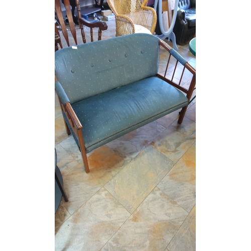 295 - Mid-century modern window seat, featuring wood frame and teal upholstery with button detailing.