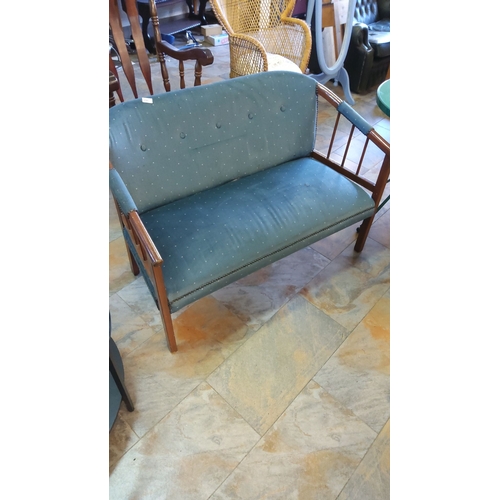 295 - Mid-century modern window seat, featuring wood frame and teal upholstery with button detailing.