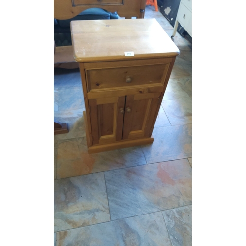 299 - Pine bedside cabinet with single drawer and double door storage.