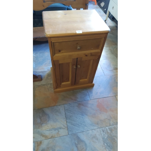 299 - Pine bedside cabinet with single drawer and double door storage.