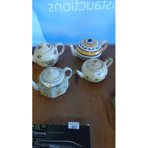 326 - Collection of four vintage ceramic teapots in various floral and geometric designs.