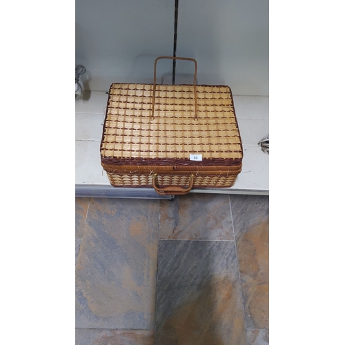 33 - Vintage woven picnic hamper with lid and handle, featuring a classic natural straw and wicker design... 