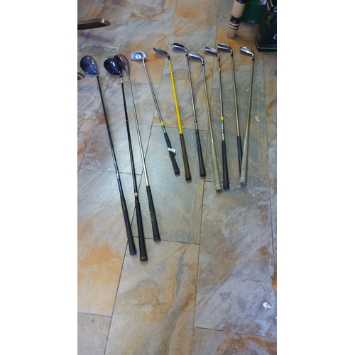 331 - Mixed lot of golf clubs, featuring woods, irons, and a putter.