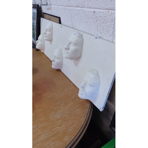 333 - Decorative Wall Panel with Plaster Cast Faces – A piece showcasing five detailed 3D face sculptures ... 