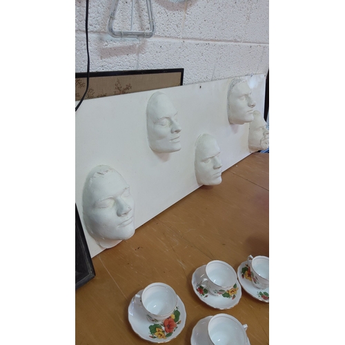 333 - Decorative Wall Panel with Plaster Cast Faces – A piece showcasing five detailed 3D face sculptures ... 