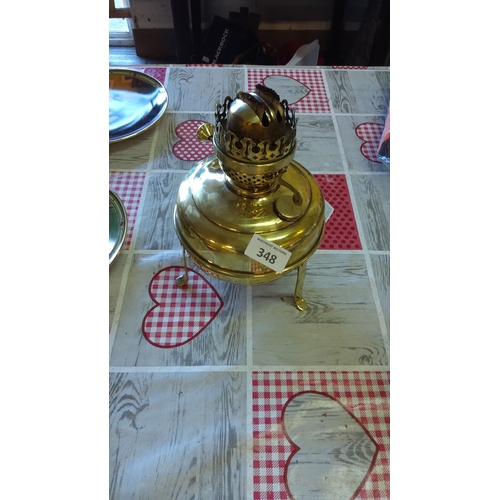 348 - Brass oil lamp with ornate burner and three-legged stand, from the mid-20th century.