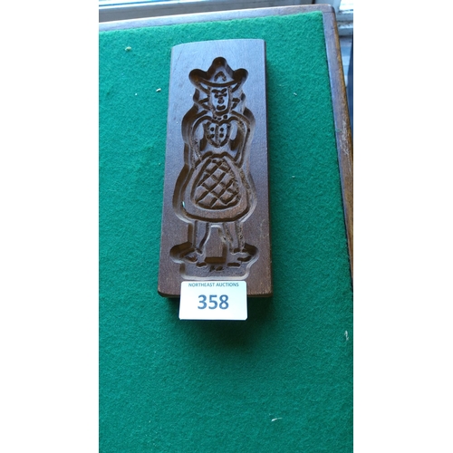 358 - Hand-carved wooden cookie mold featuring a traditional Dutch figure in detailed attire.