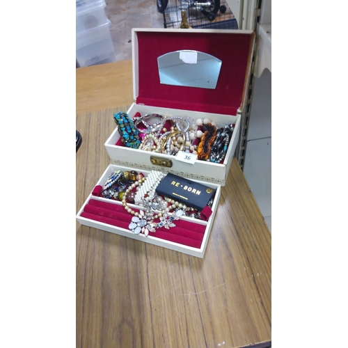 36 - Vintage jewelry box with mirrored lid, red velvet lining, and assorted costume jewelry. Includes bra... 