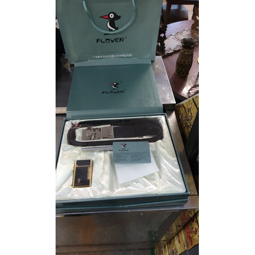 476 - Includes leather belt with metallic buckle, elegant lighter, and branded pen. Presented in original ... 