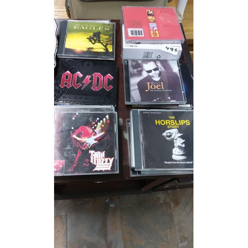 495 - Collection of iconic music CDs, featuring artists such as AC/DC, The Eagles, Thin Lizzy, and Billy J... 