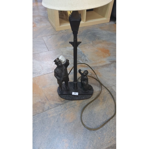 59 - Vintage figurative table lamp, cast metal base featuring Victorian street scene characters. Complete... 