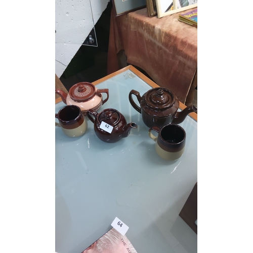 62 - Collection of vintage ceramic teapots and matching mugs, showcasing rich brown and cream glazes. Cla... 