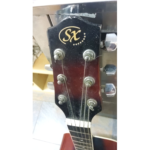 63 - Acoustic Guitar with sunburst finish, six-string configuration, and chrome tuning pegs.