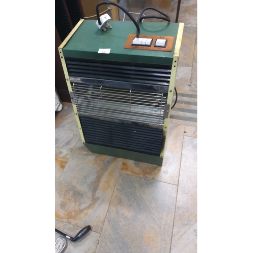 68 - Vintage electric heater, circa 1970s, features a robust green and yellow design. It is fully functio... 