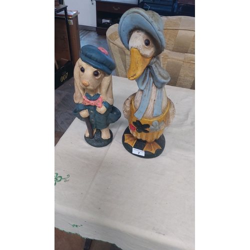 7 - Painted resin figurines include an anthropomorphic dog with a cane and a duck in a bonnet.