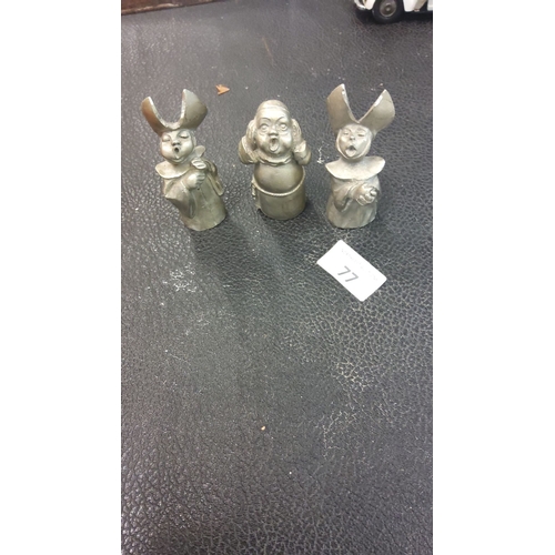 77 - Set of three whimsical metal figurines depicting expressive characters in theatrical poses, featurin... 