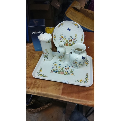 82 - Aynsley bone china floral and butterfly collection includes plastic tray, vases, pitcher, and plate.... 