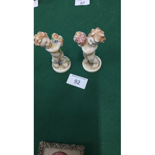 92 - Pair of vintage German Hummel porcelain cherub figurines, hand-painted with floral accents, marked 