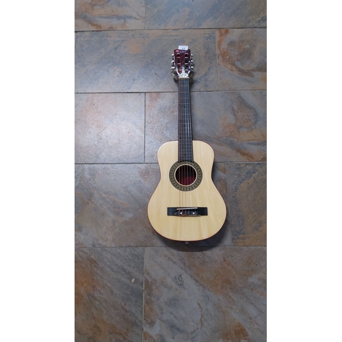 17 - CB Sky junior classical acoustic guitar with natural wood body, red headstock, and nylon strings.