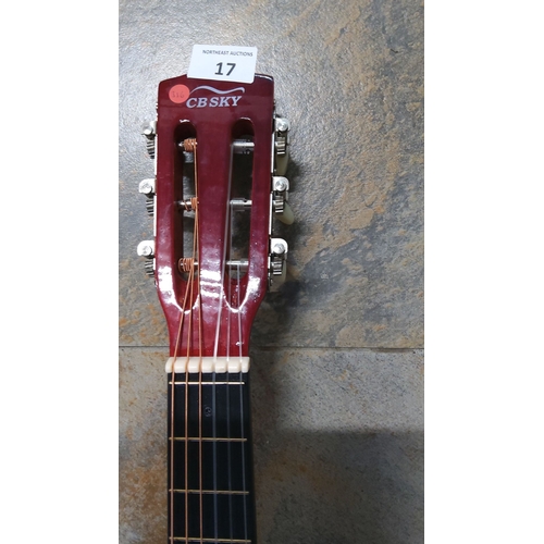 17 - CB Sky junior classical acoustic guitar with natural wood body, red headstock, and nylon strings.