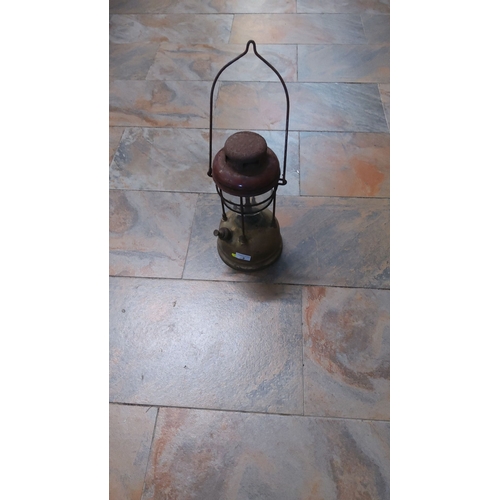 2 - Vintage brass and steel kerosene lantern with a robust wire handle, from mid-20th century, showcasin... 