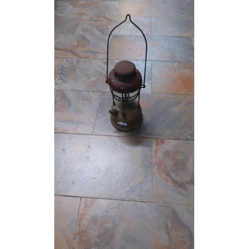 2 - Vintage brass and steel kerosene lantern with a robust wire handle, from mid-20th century, showcasin... 