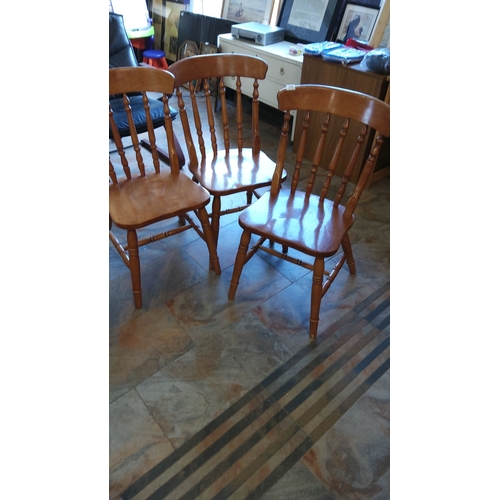 318 - Set of three vintage wooden spindle-back chairs feature a warm honey finish and sturdy construction.... 